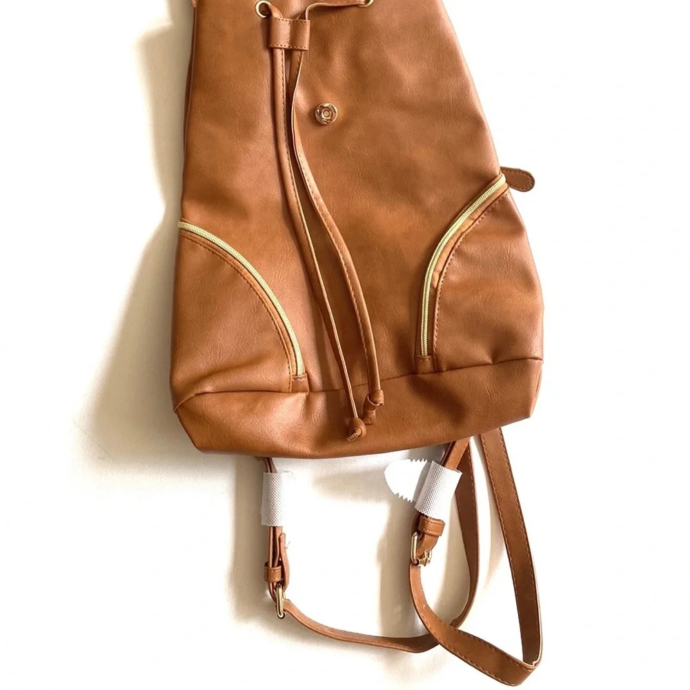 Brown backpack with zipper‎ accented detailing on front, NWOT